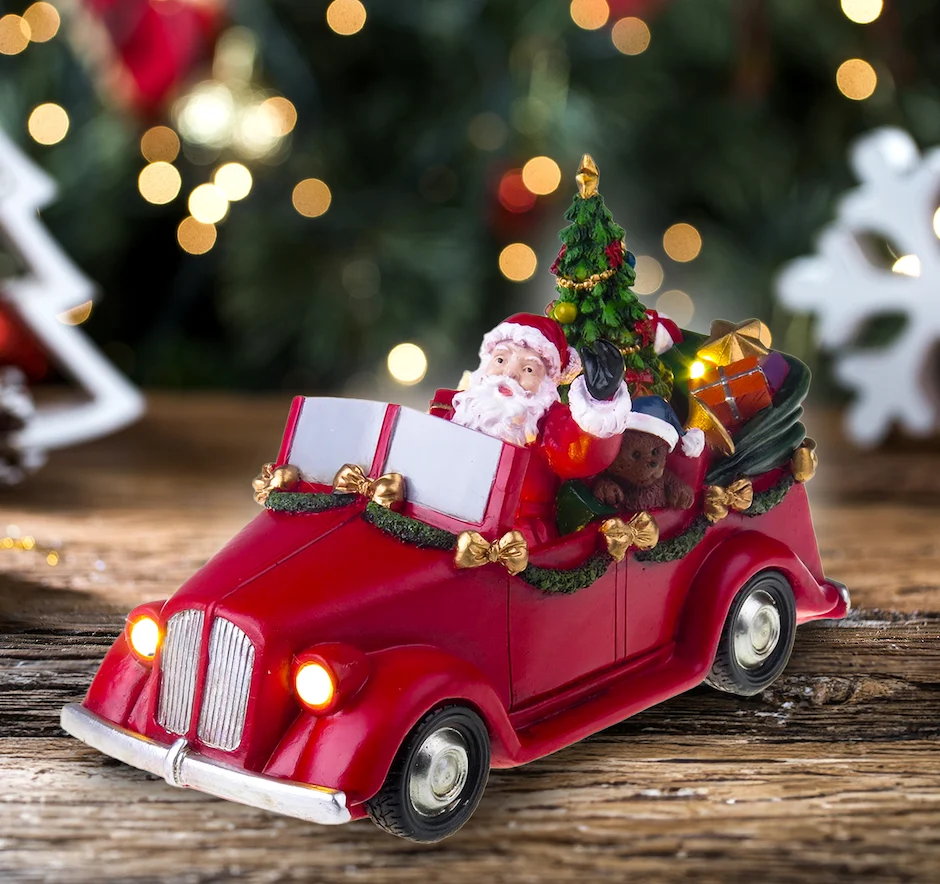 Julemanden i bil med drejende træ